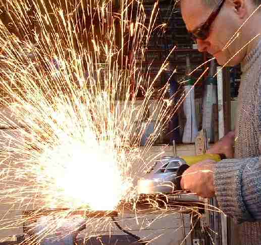 Angle grinding a workpiece ready for welding